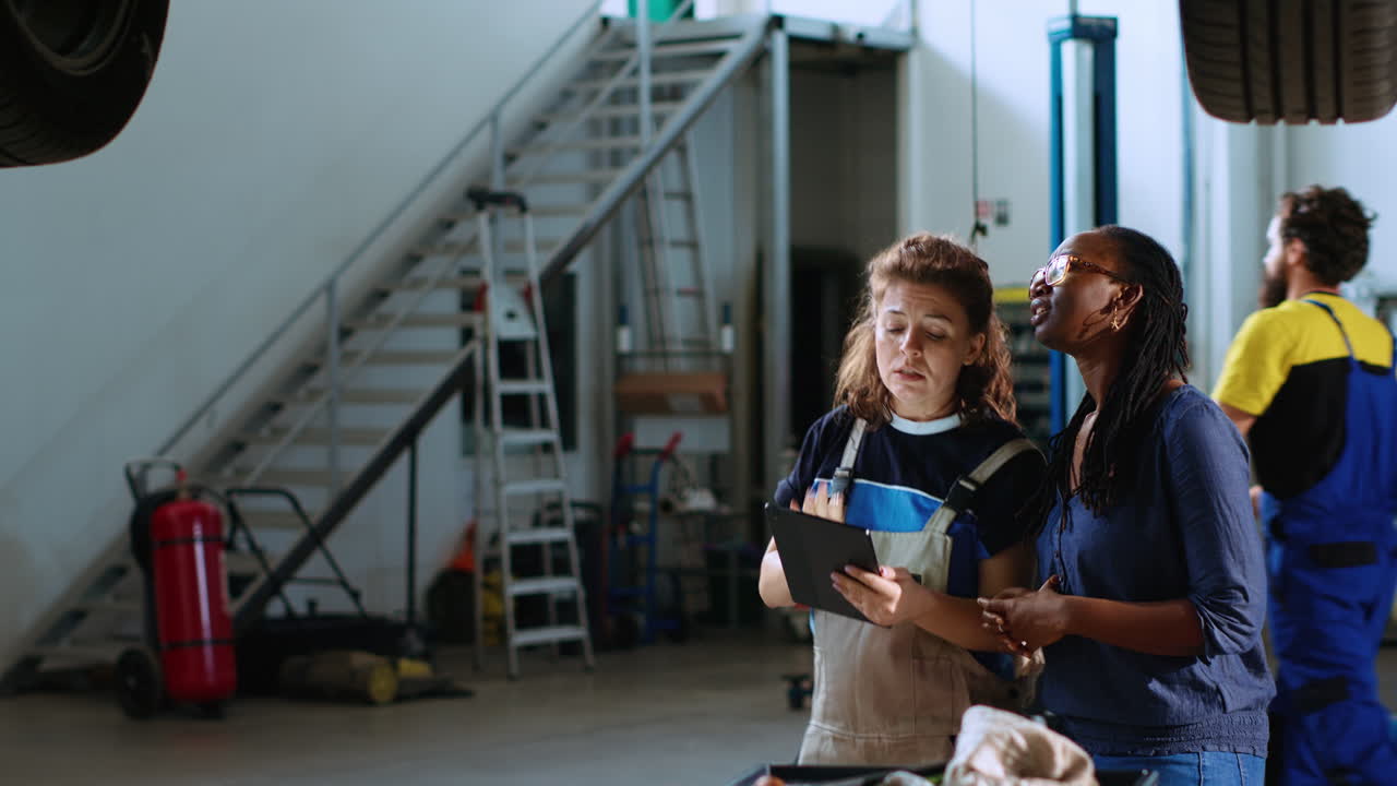 Engineer and woman look for car parts