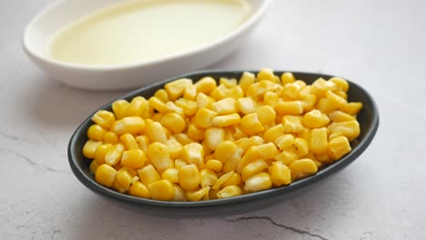 canned corn in a bowl with oil