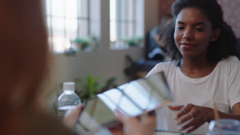 young-diverse-business-people-meeting-using-tablet-computer-viewing-financial-data-on-screen-brainstorming-ideas-for-successful-marketing-project-working-together-in-office-boardroom