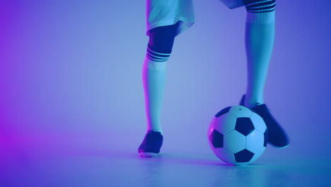 demonstrating-dribbling-skills-in-studio-closeup-of-feet-of-talented-football-player