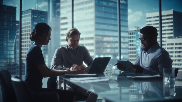 Multiethnic Diverse Office Conference Room Meeting: Team of Three Creative Entrepreneurs Talk, Discuss Growth Strategy. Stylish Young Businesspeople Work on Digital e-Commerce Startup Project.
