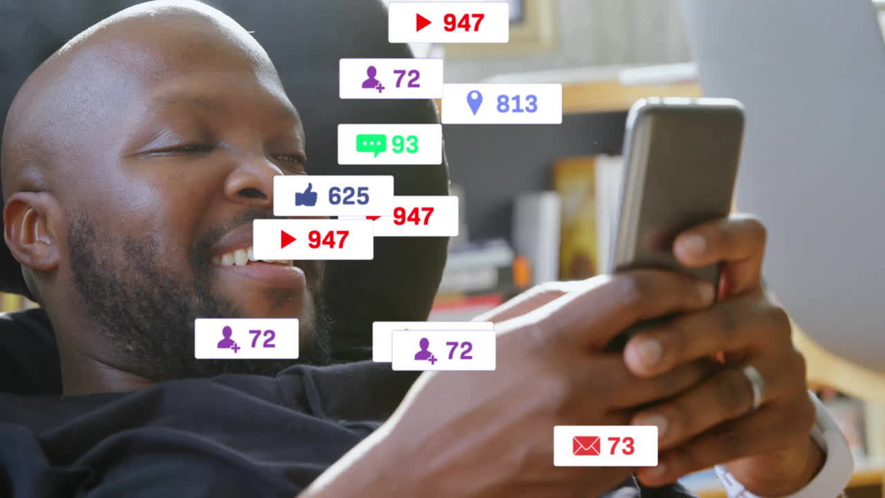 Engaging with social media notifications, man smiling while using smartphone