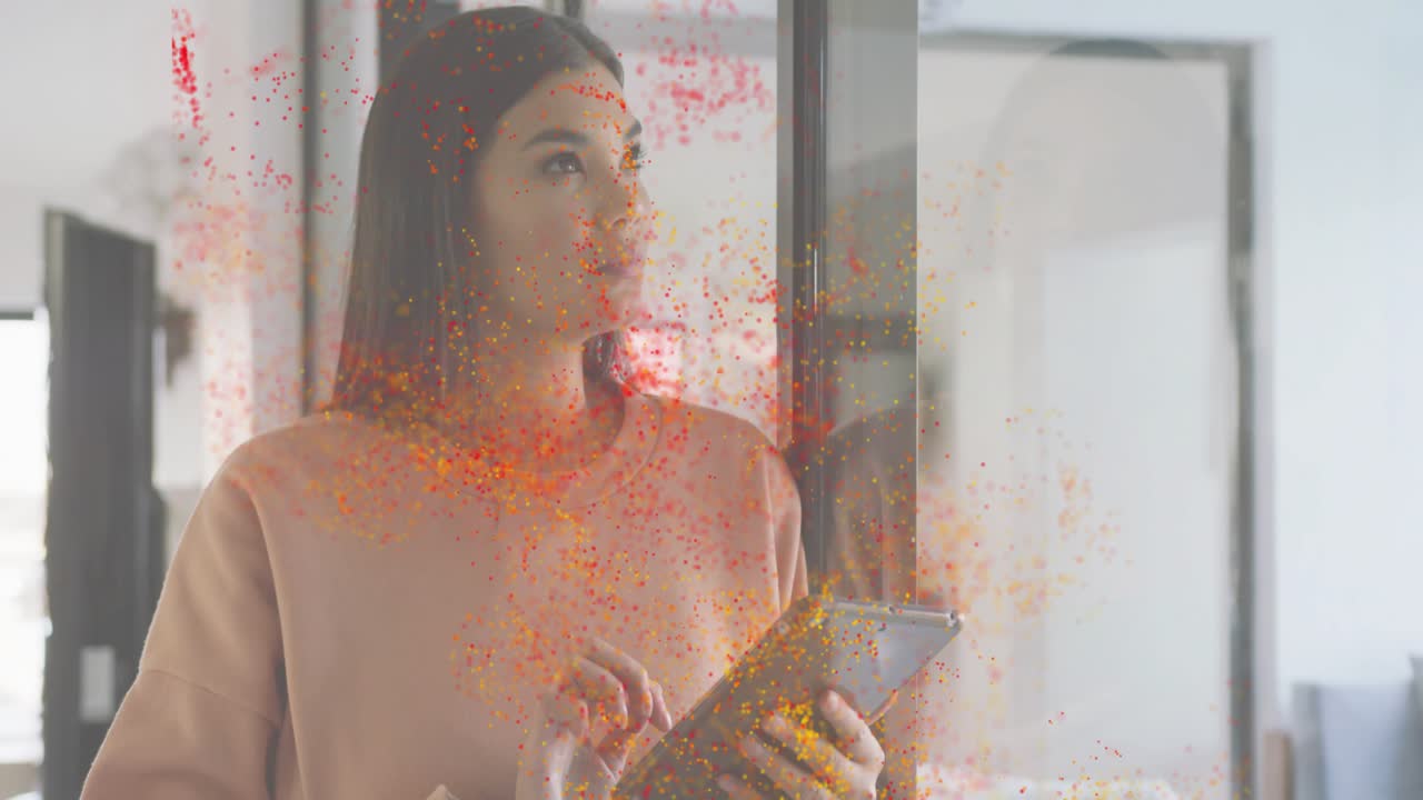 Adult woman tapping tablet screen, activating particles swirling around living room for tech demo