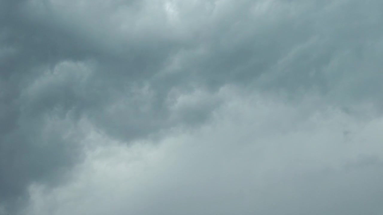Dark dramatic storm clouds gathering in the sky before a thunderstorm, creating a moody and atmospheric weather background.