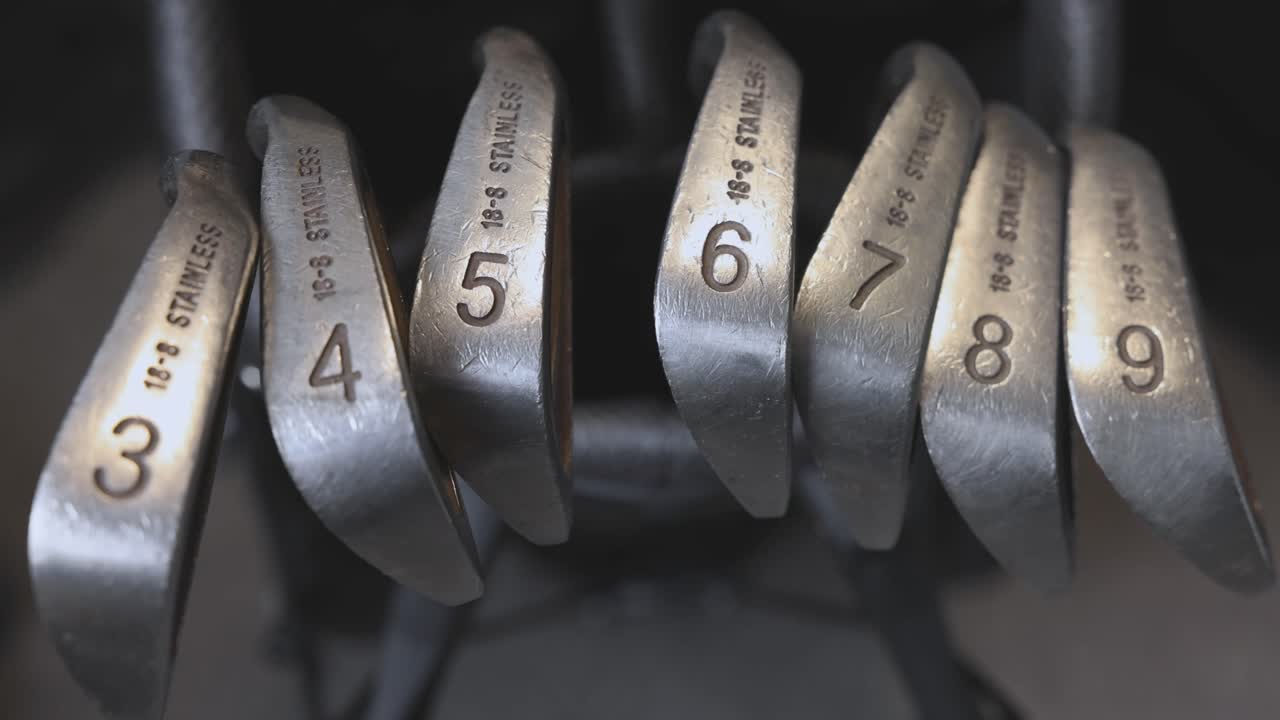 static shot of a full set of golf irons organised within a golf bag