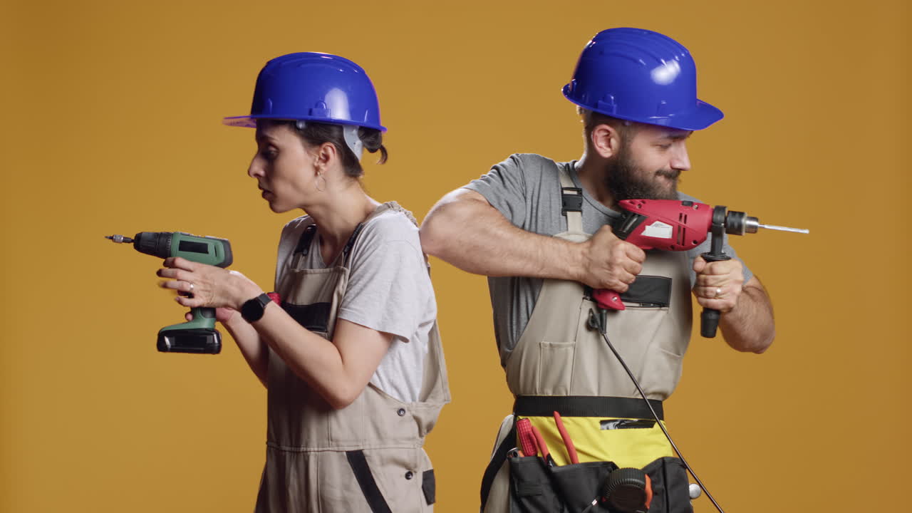 Team of engineers using power drill machine to screw nails
