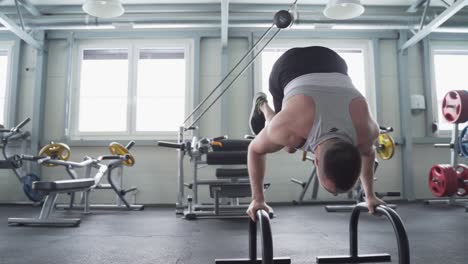 strong athlete with prosthetic leg balancing on calisthenics bars