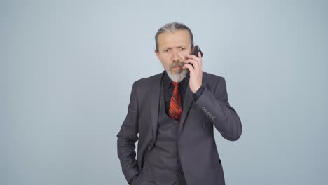 Businessman-getting-interrupted-and-angry-while-talking-on-the-phone.