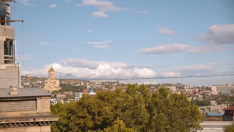 tbilisi, georgia time-lapse at freedom square monument, clouds and blue sky.
