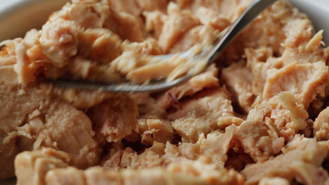 Smoked cod liver in oil in open tin can with fresh greens on wooden table. Seafoods delicacy. High quality 4k footage