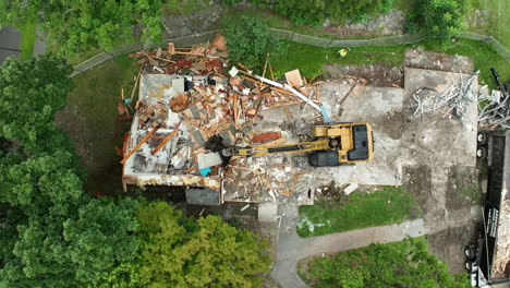 aerial view of building demolition with excavator