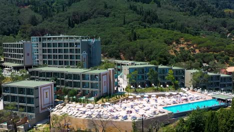 beautiful total view tracking shot of coastline greece, hotels, trees, beach, no people, daylight, a sunny day