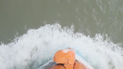 top-down-of-bow-of-small-wooden-Indian-fishing-boat-cutting-through-water-slow-motion