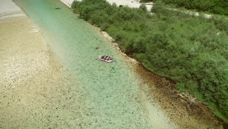 aerial view of a group of rafters rafting in turquoise blue water at soca river.