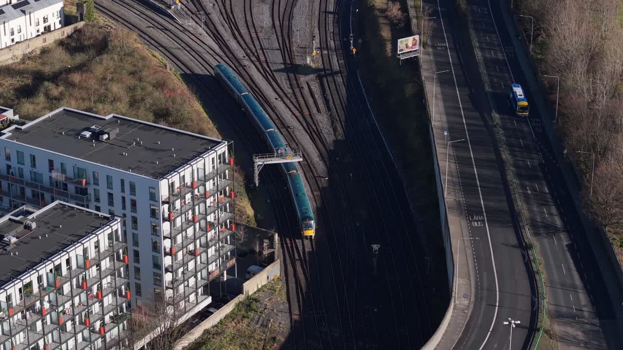 City Train Leaving Heuston Railway Station In Dublin, Ireland. - aerial shot