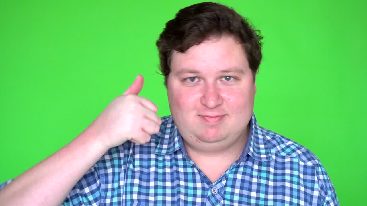 그린 스크린에 대한 큰 남자에 의해 엄지손가락을 올립니다.