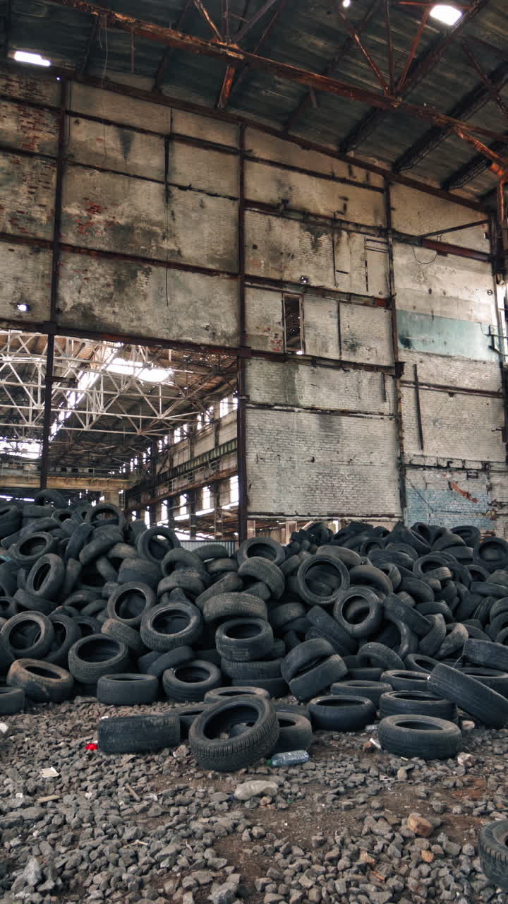 Wheel of cars in recycling. Old rubber wheels for trash factory recycling Vertical video