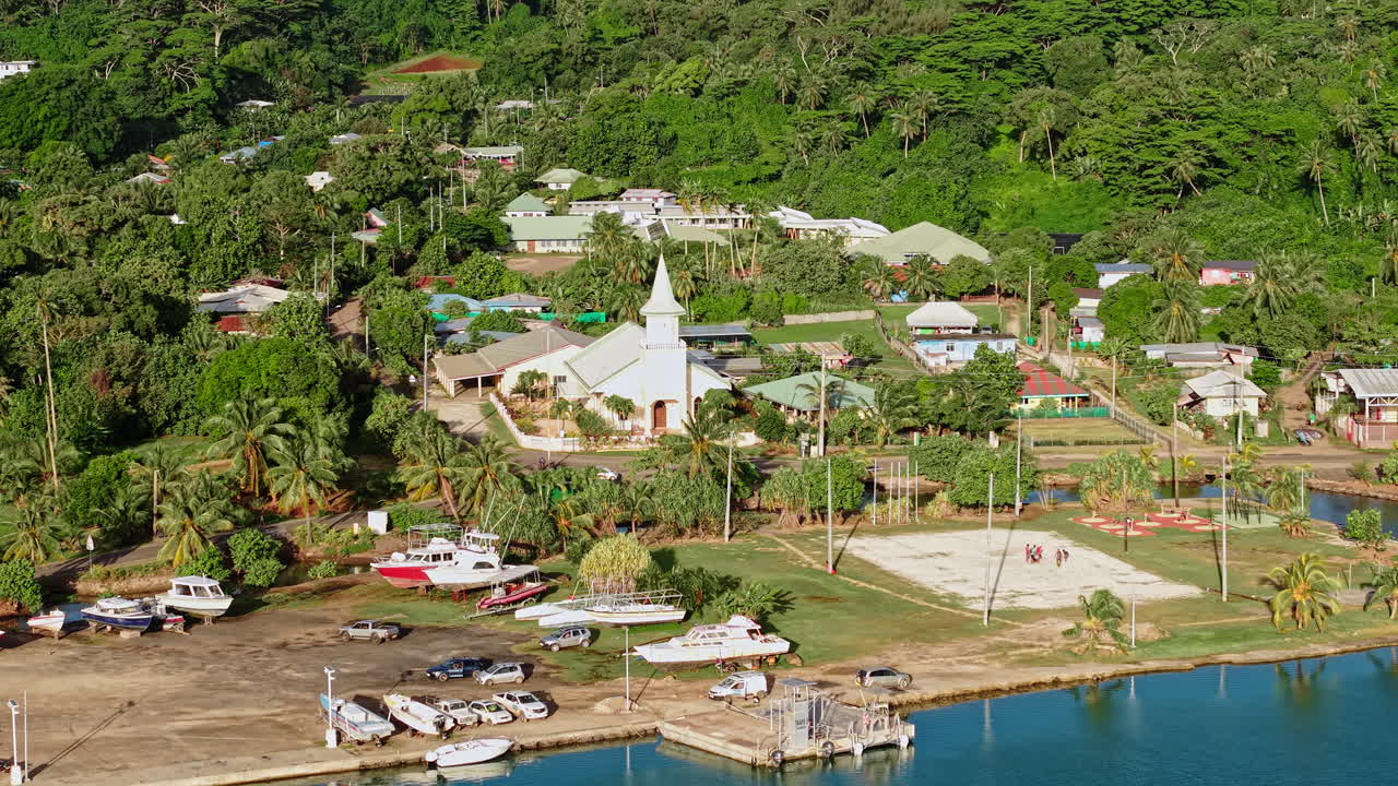 Bora Bora, French Polynesia. Drone Shot of Village on Main Island, Protestant Church, Buildings and Road Traffic