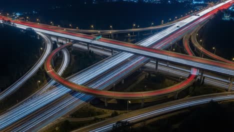 nighttime highway interchange with light trails