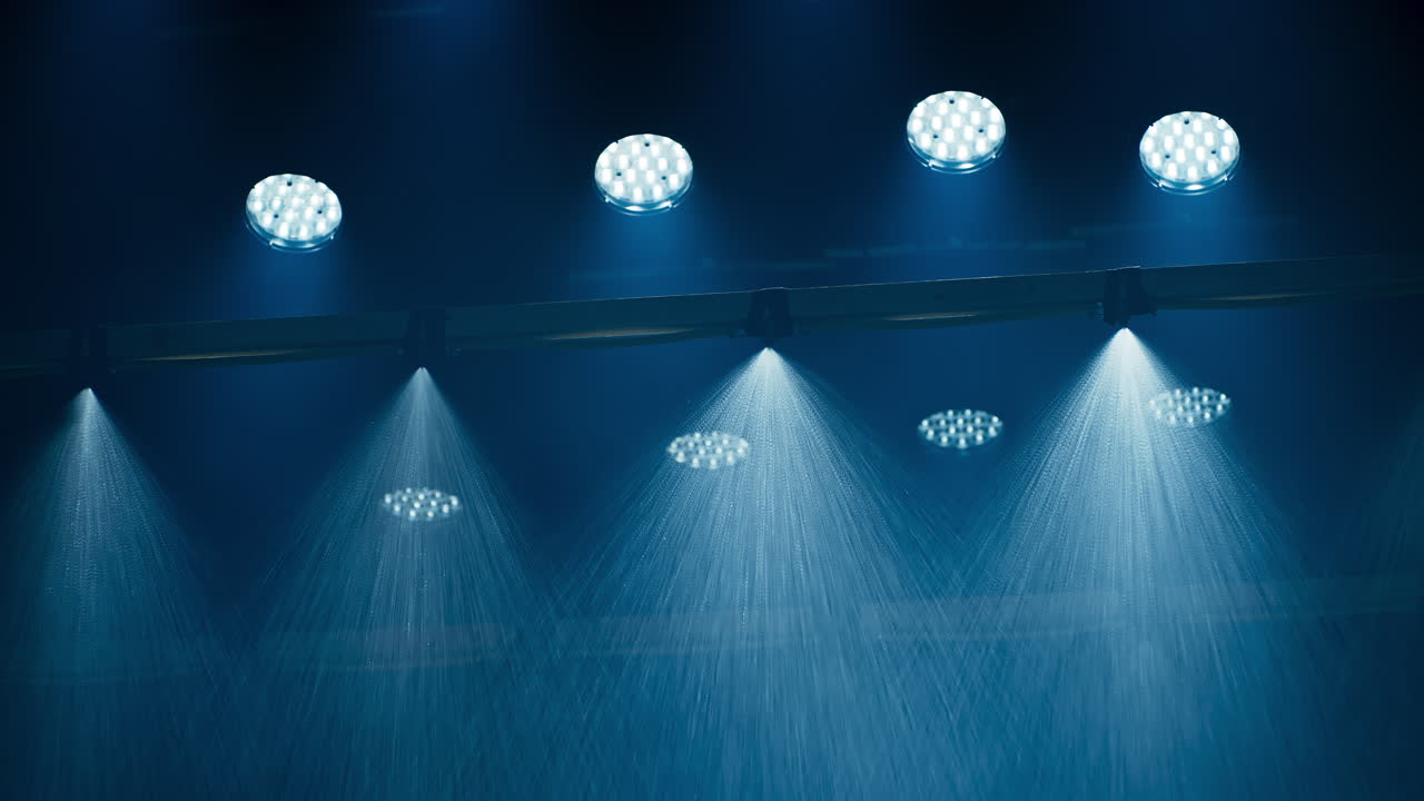 A special effects rain machine in a film cinema studio with a ceiling full of film lights