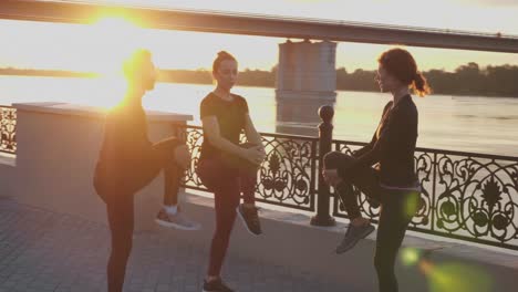 people stretching outdoors at sunrise by the river
