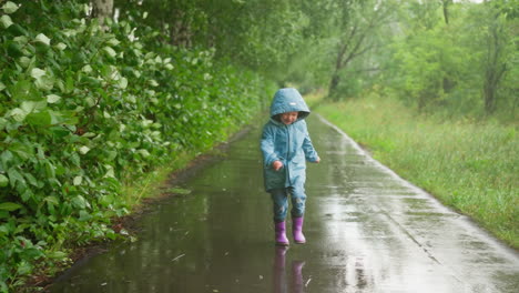 kid splashes through rain water in garden child leaves behind trail of footprints marking passage