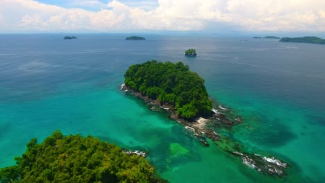 Antena-Hacia-Atrás-Que-Muestra-Islas-Bordeadas-De-Coral-Y-Una-Cala-De-Playa-Privada-Con-Islas-Distantes.