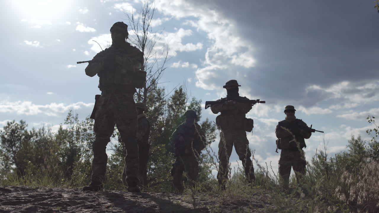 Silhouette of Military Personnel on Patrol
