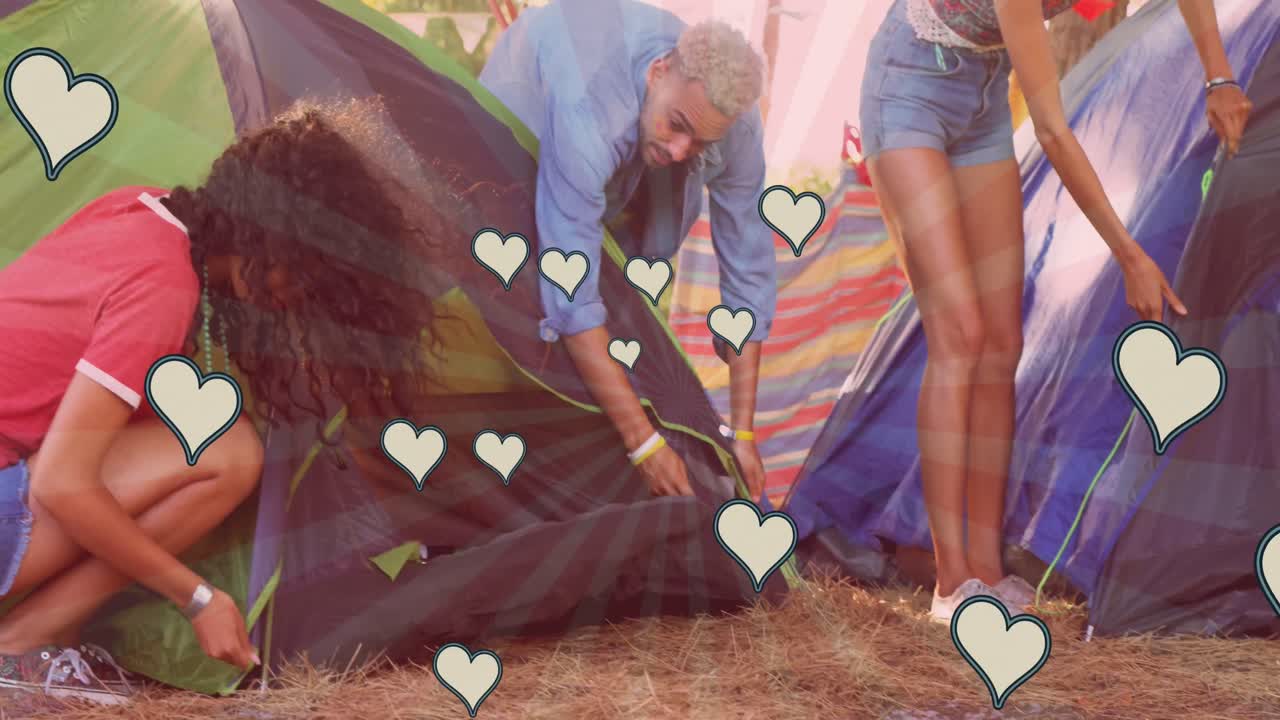 animación de los corazones sobre diversos amigos preparando tiendas