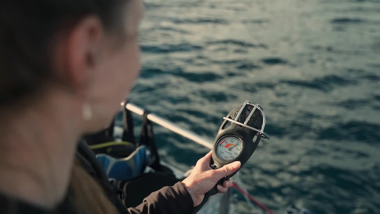 Female Scuba Diver Air Gague Being Turned On