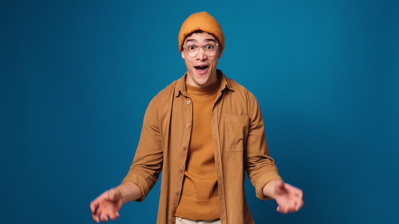 Excited man in beanie and glasses