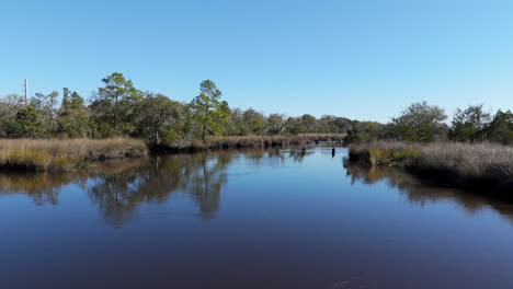 Aerial-footage-following-the-water-of-a-river-in-southern-Georgia-with-blue-skies