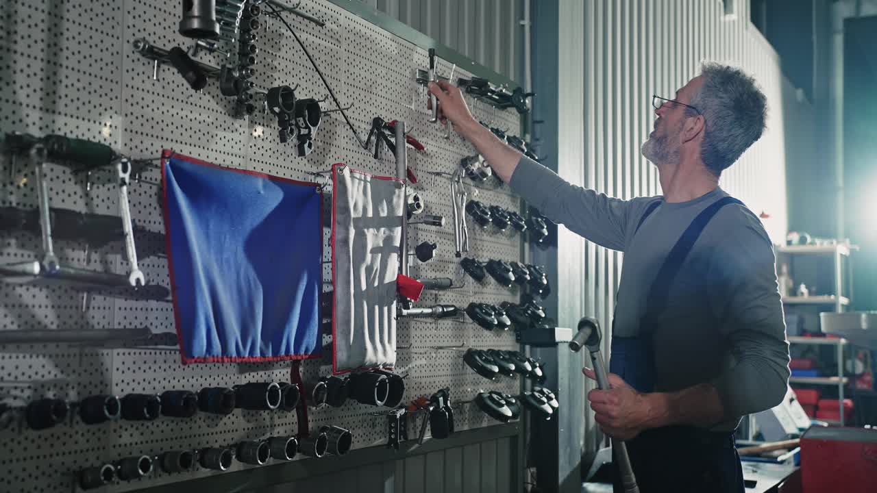 Mechanic inspecting tools in a workshop