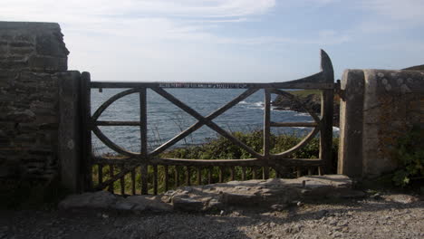 wide shot of an ornate wooden gate at bessy's cove, the enys