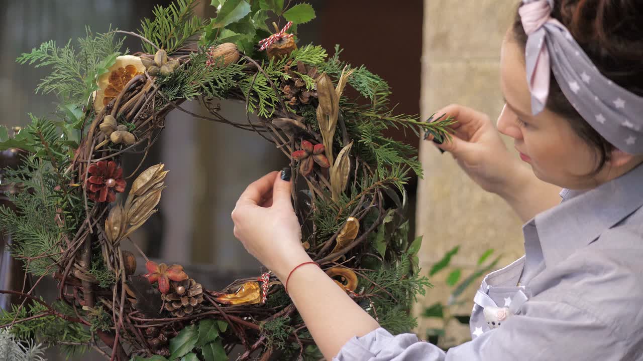 Florist at work. How to make christmas wreath with floral arrangement. Step by step, tutorial