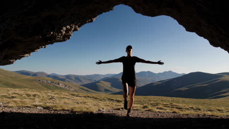 Woman enjoying a mountain view from a cave