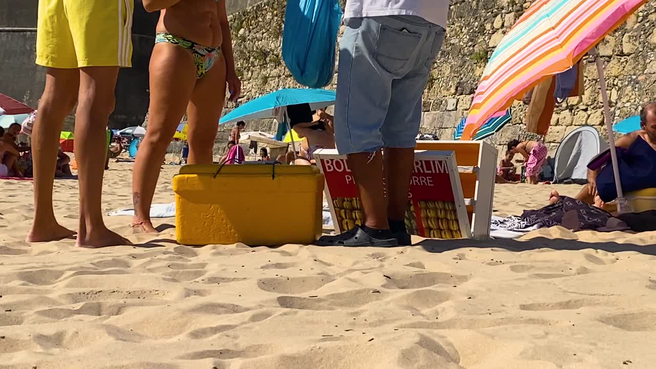 Berlin balls being handed out on a sunny beach day in Portugal