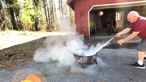 man rushing to put out fire with fire extinguish