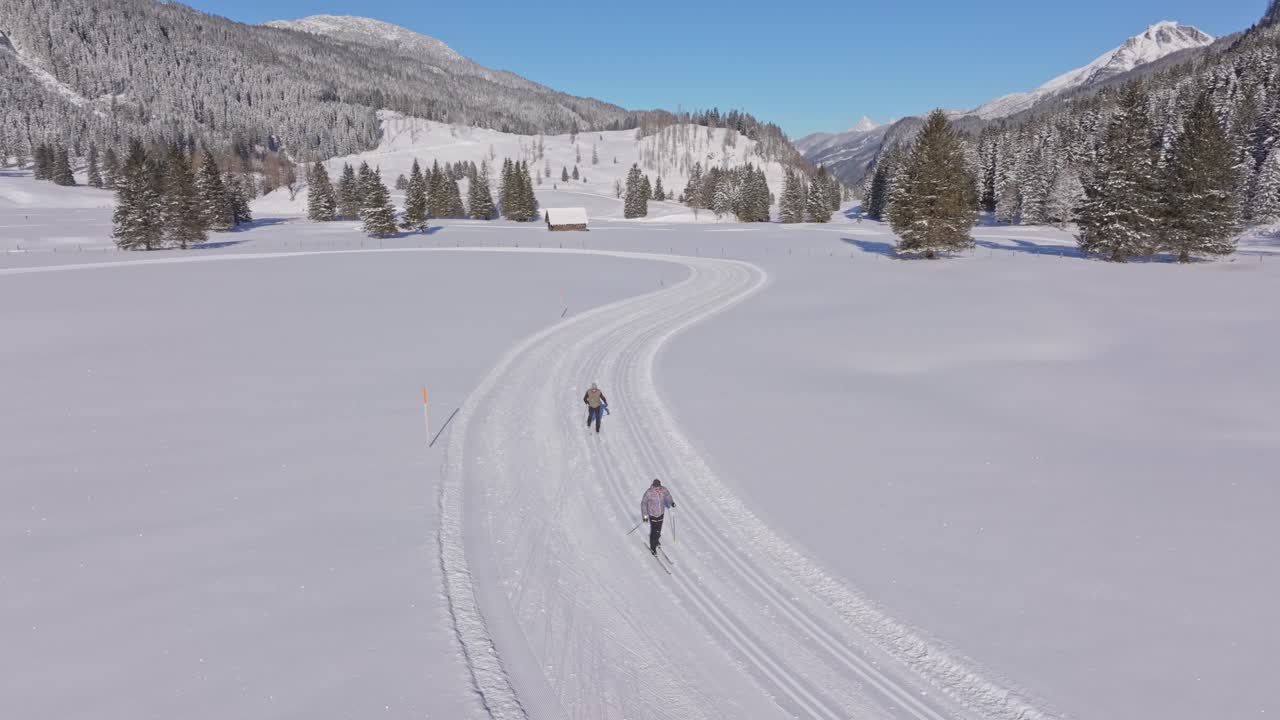Aerial view of skiers trekking through Austrian snow on cross-country skis
