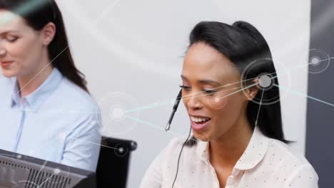 Animation-of-network-of-connections-over-office-workers-wearing-headsets