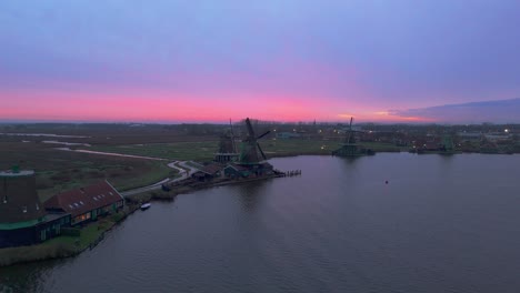 dronevideo of the windmills of zaanse schans (close to amsterdam) in the early dawn lights.