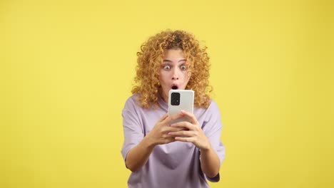 surprised woman reacting to something on her smartphone