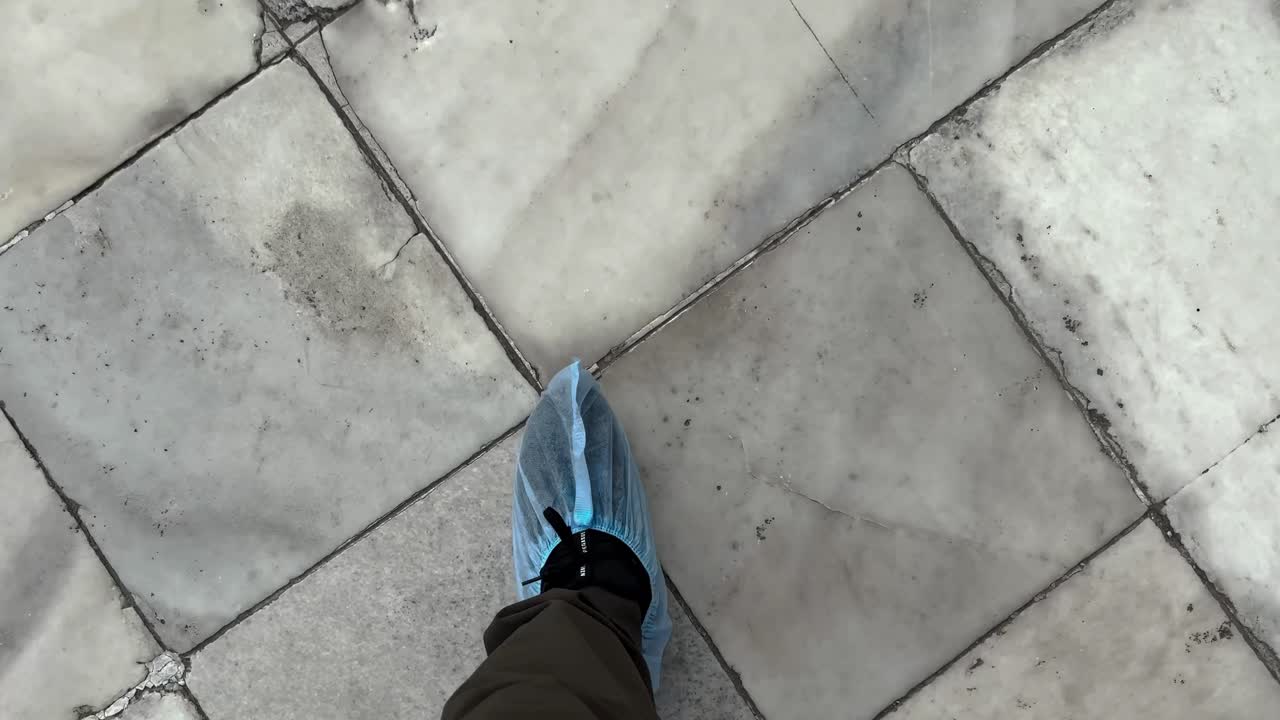 POV Of A Person Walking With Feet Covered On Taj Mahal In Agra, Uttar Pradesh, India.