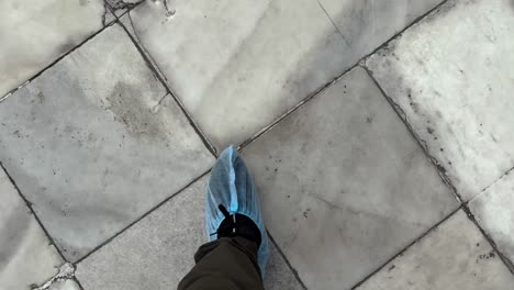 pov of a person walking with feet covered on taj mahal in agra, uttar pradesh, india.
