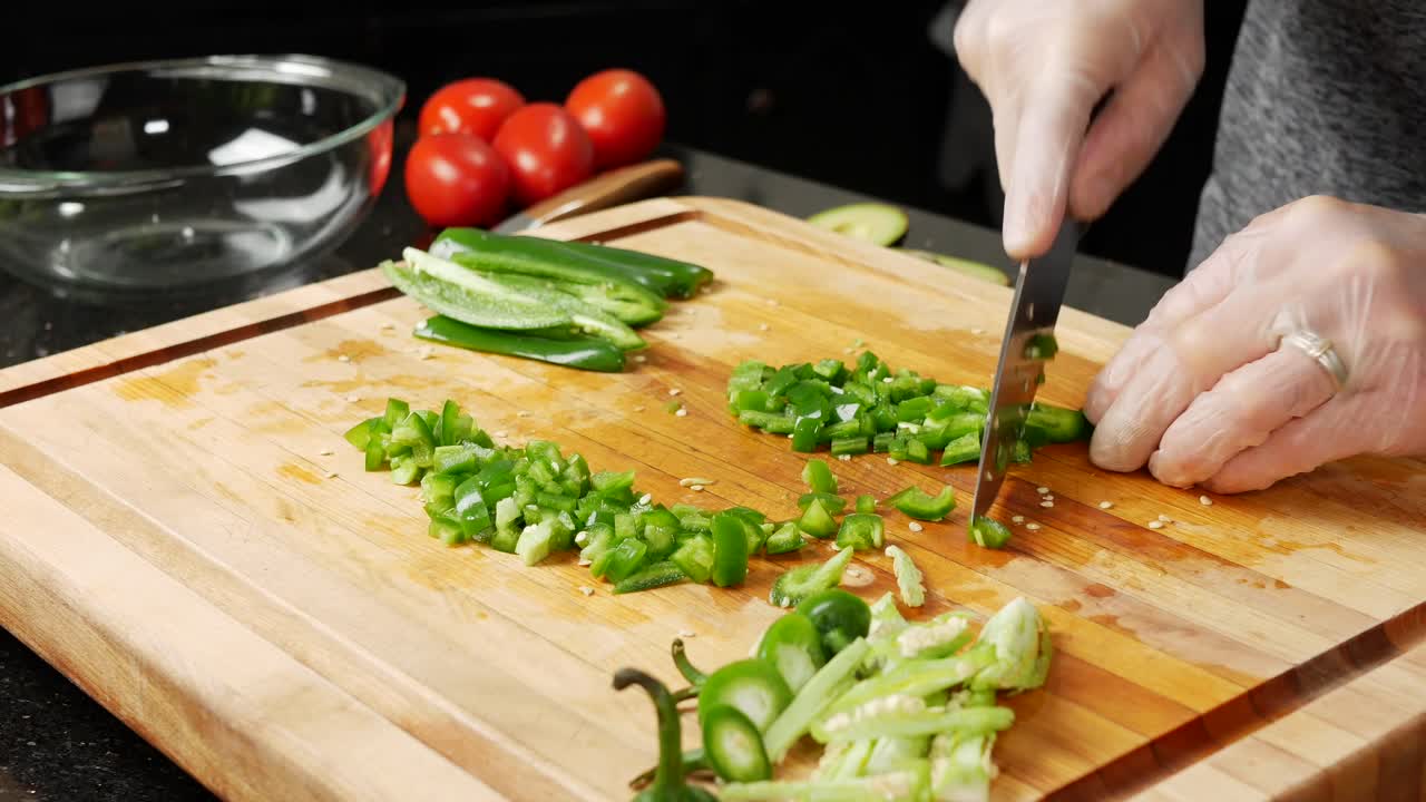 Dicing or chopping Jalapeño chili peppers.
