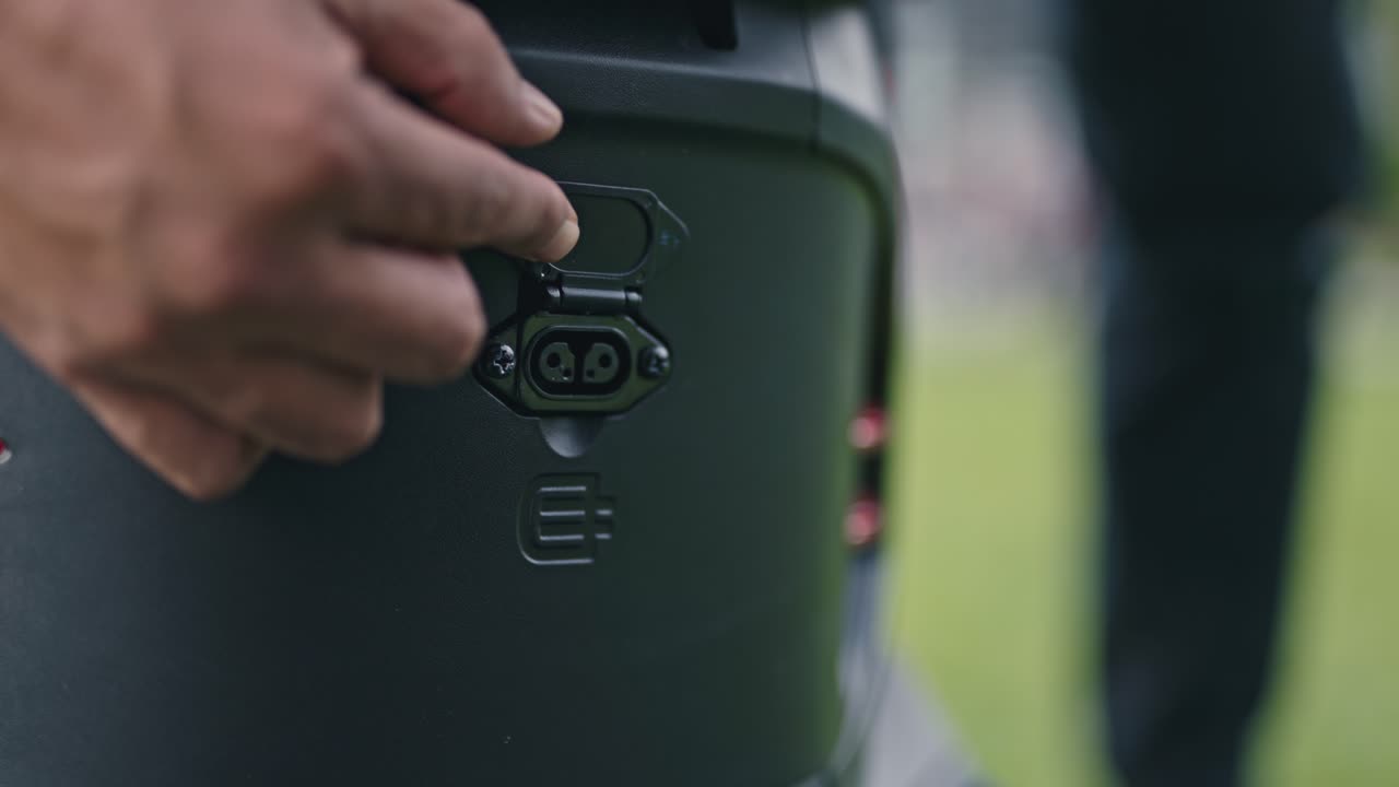 Close-up of an electric scooter charging hub, showing connectors, ports, and modern charging infrastructure for urban mobility and clean transport
