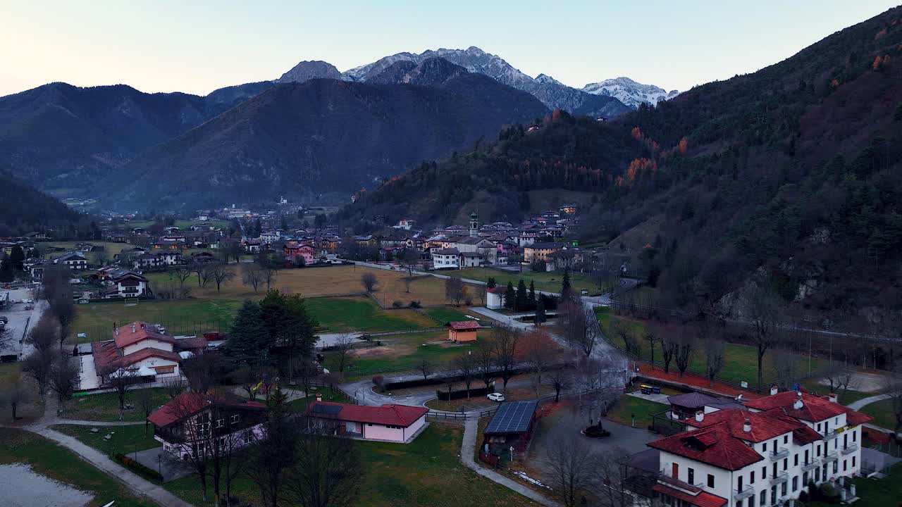 Aerial Panning Forward Drone shot of Pieve di Ledro, its Lido's Hotel and Bell Tower Church at the end