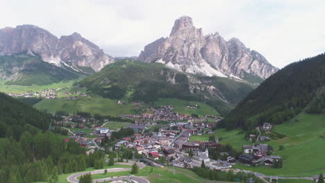cyclist riding on a road in the dolomites, italy, from a drone