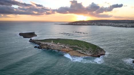 drone video moving left around the saint paul's islands in malta at sunrise