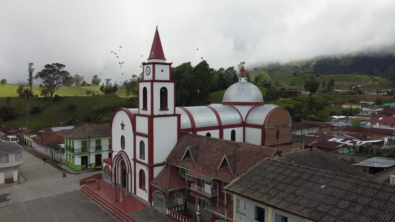Aerial View of a Church and Village in a Mountainous Landscape